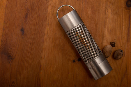 nutmeg grater on a rustic wooden table .cooking concept, spices.の写真素材