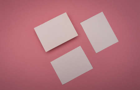 three blank business cards on pink background, mock up branding.の写真素材