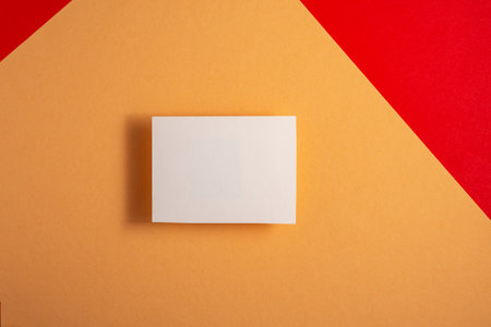 white business card mock up on red and yellow background for your design.の写真素材
