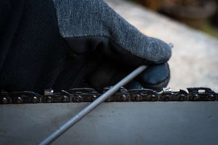 hand sharpening a chain saw blade with a round file. do it your self.