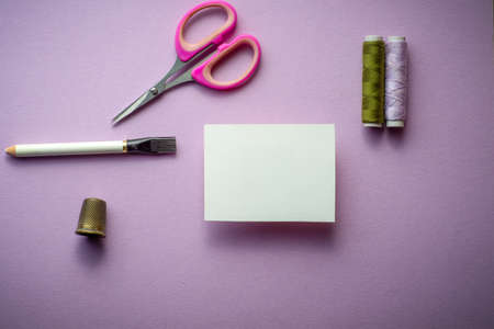mockup business card for sewing or textile, tailor or home made. on mauve background.の写真素材