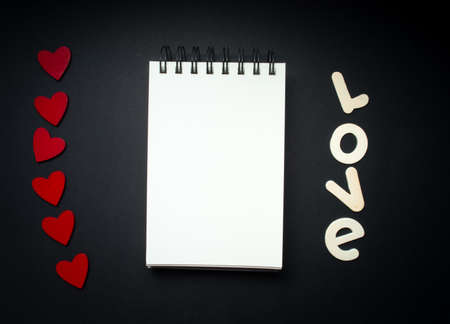 romantic valentine mock up with blank note on black background with hearts for your message, copy...