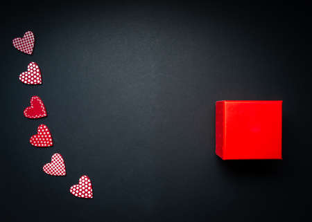 romantic valentine mock up with red present on black background with red hearts for your message,...