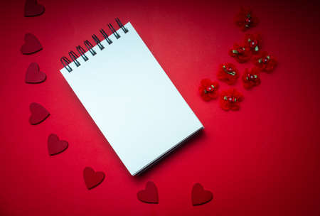 romantic valentine mock up with blank note pad on red background with hearts for your message, copy spaceの写真素材