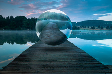 surreal sphere floating in the middle of a beautiful landscape, concept of mental health, living in a bubble, loneliness and isolation.の写真素材