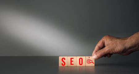 hand posing wooden block SEO Search Engine Optimization and Marketing Ranking Traffic to Website Internet Business Conceptの写真素材
