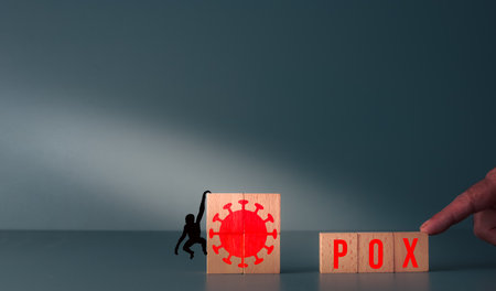 monkey virus background with copyspace for your text monkey hanging from wooden blocks with virus symbol and pox written on themの写真素材