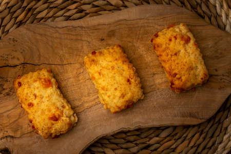 home made cheese scones on a wooden chopping board, cooking at home