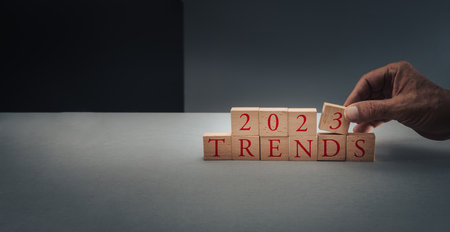 concept of trends for 2023 ,hand posing blocks on blue gray background with copy space .の写真素材