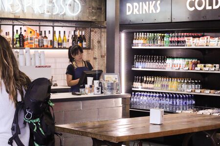 Queenstown, New Zealand 30 January 2020: Asian woman at till and corona beer in bucketのeditorial素材