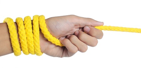 hand was pulling yellow ropeの写真素材