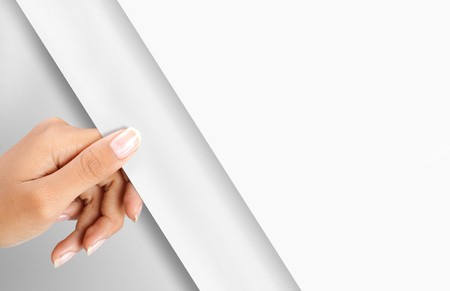 gesture of hand turning white paper pageの写真素材