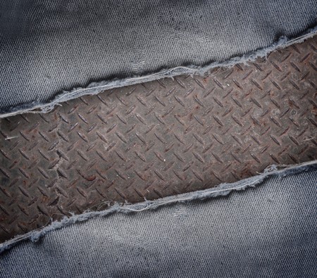ripped jeans and rusty metal texture backgroundの写真素材