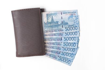 still life photo of wallet and money over white background