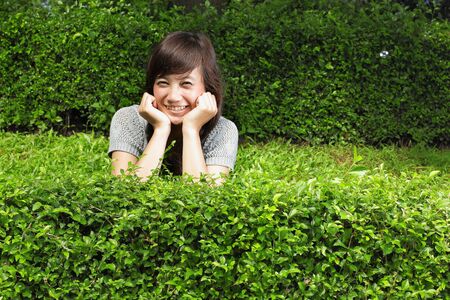 young beautiful smiling woman outdoorsの写真素材