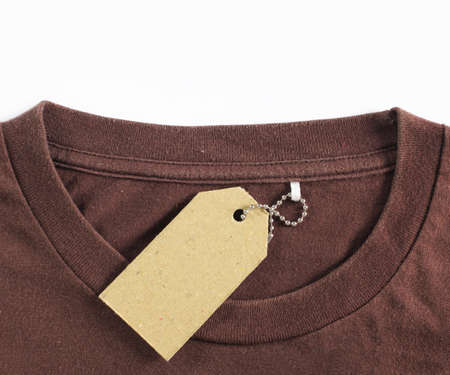 price tag hang over brown tshirt. isolated over white backgroundの写真素材