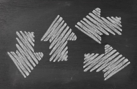 Drawings of arrow on blackboard with chalkの写真素材