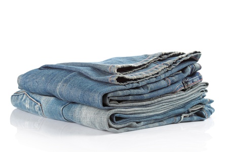 stack of blue jeans on a white backgroundの写真素材