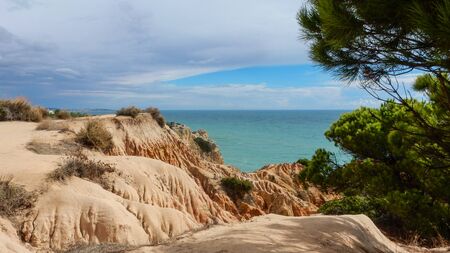 Panoramic view of the Algarve ocean cliffs, Portugal, with cloudy dramatic skyの写真素材