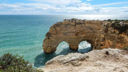Panoramic view of the Algarve ocean cliffs, Portugal, with cloudy dramatic skyの写真素材