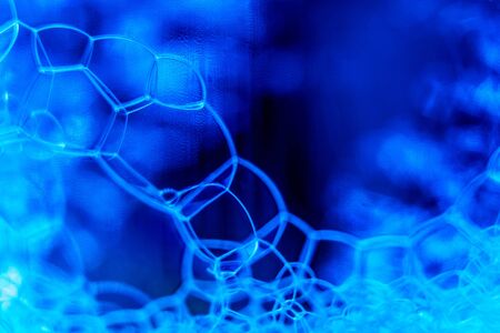 Abstract macro clean blue foam shot background of soap bubblesの写真素材