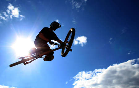 A mountainbiker flys across the sky during a freeriding contest held in Whistler, BC.の写真素材