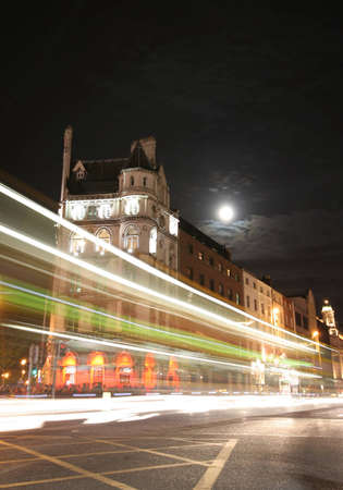 A long exposure photo of traffic passing a building in historic Dublin.の写真素材