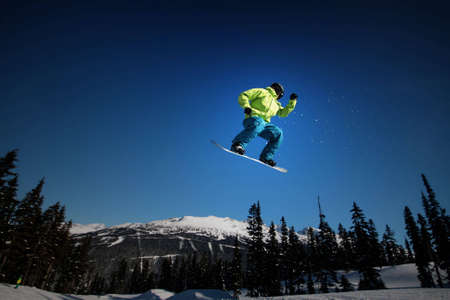 A snowboarder takes flight on Whistler Mountain.の写真素材