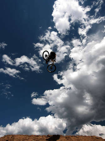 A mountain biker soars over his landing at a competition in Winter Park, Colorado.