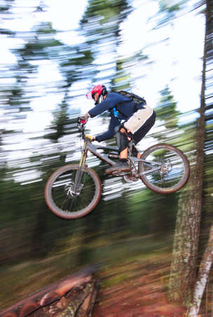 A skilled mountin biker leaps off of a jump near Hood River, Oregon.