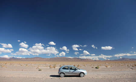 A car stopped on the side of a dirt road in the middle of nowhere.の写真素材