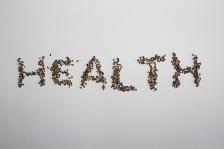 Health written with chia seeds isolated on whiteの写真素材