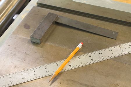 A carpenter's square, ruler and number 2 pencil.