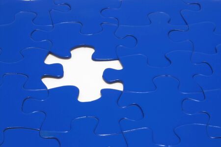 A close-up of a jigsaw puzzle with a missing puzzle piece.の写真素材