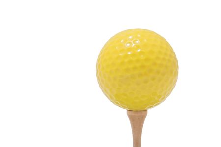 A yellow golf ball on a golf tee.の写真素材