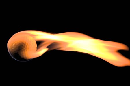 A flaming golf ball rocketing through space.の写真素材