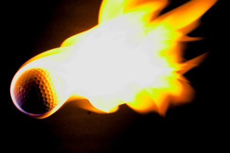 A flaming golf ball rocketing through space.の写真素材