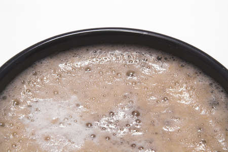 A piping hot mocha latte in a coffee cup.の写真素材