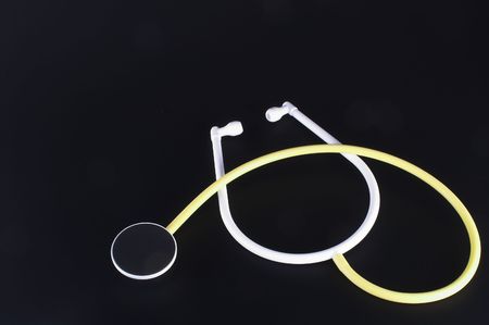 A medical stethoscope on a dark background.の写真素材