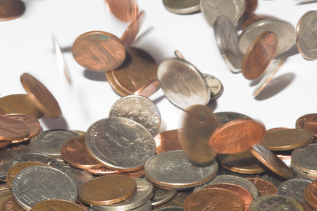 A mixture of various coins falling from the air.の写真素材
