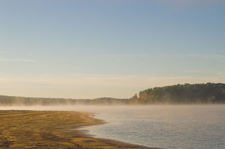 A misty fog over a lake in the early morning.の写真素材