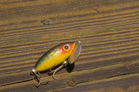An old fishing lure sitting on a pier.の写真素材