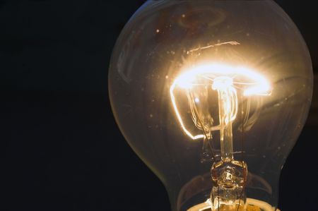 An incandescent light bulb with a burning filament.