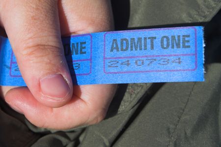 A person holding a string of admission tickets.の写真素材