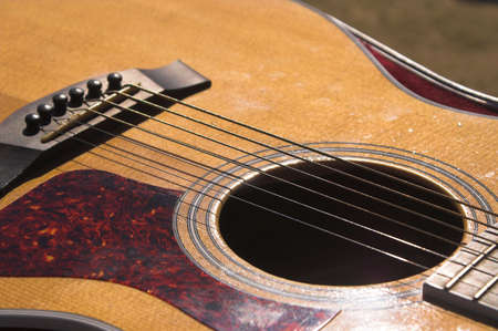 A close-up view of an acoustic guitar.の写真素材