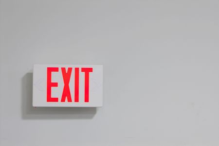 An exit sign on a wall marking the way out.の写真素材