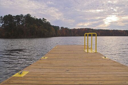 A boat dock on a lake in the atumn.の写真素材