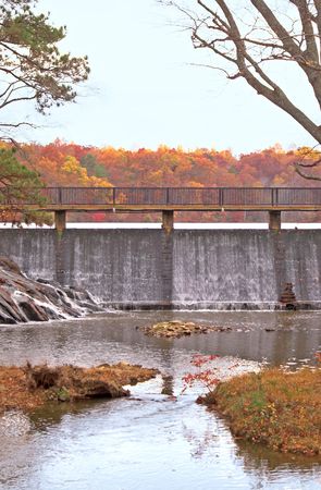A flowing waterfall with colorful autmn foliage.の写真素材