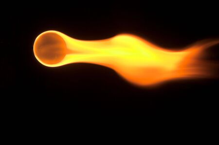 A flaming ball rocketing across the night sky.の写真素材