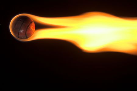 A flaming basketball rocketing across the night sky.の写真素材
